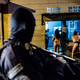 A police patrol drives past a brothel in San Salvador
